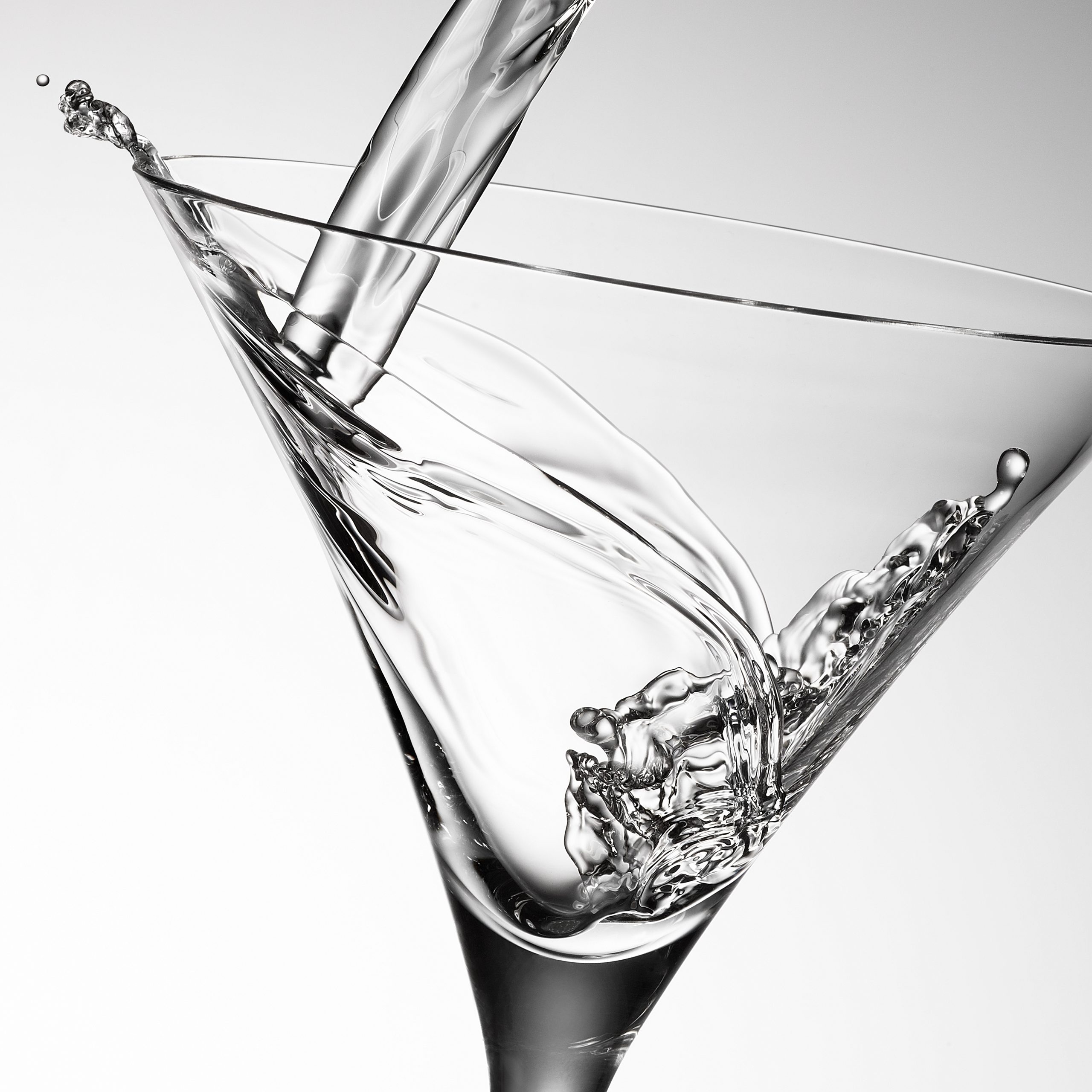 Martini pour in a glass photo by Jens Johnson Photography. Premium food, beverage, and product photography for Connecticut and New York.
