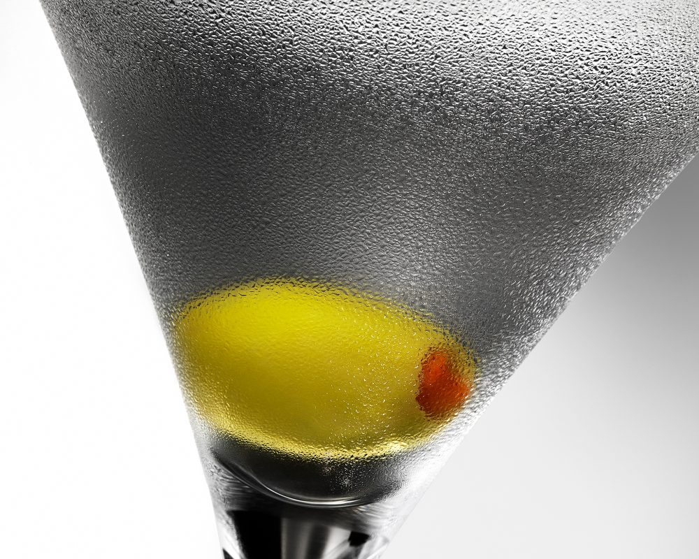 Martini Glass Condensation and Olive  photo by Jens Johnson Photography. Premium food, beverage, and product photography for Connecticut and New York.